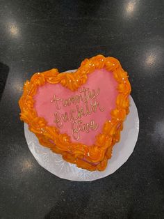 a heart shaped cake with writing on it