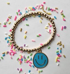 Smiley face charm bracelet. Fun Blue Bracelets For Gifts, Cute Blue Stretch Bracelet For Birthday, Trendy Blue Charm Bracelet For Gift, Fun Blue Beaded Bracelets For Gifts, Trendy Blue Charm Bracelet Gift, Nickel Free Stretch Bracelet Gift, Personalized Blue Charm Bracelet For Birthday, Cute Blue Bracelet For Birthday, Playful Blue Beaded Bracelets As Gift