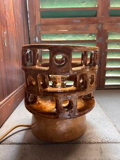 a wooden object sitting on top of a cement floor