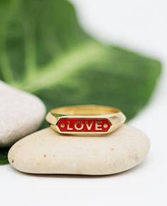 "A personalized signet ring, made of solid 14k yellow gold and colorful enamel inlay. A customized name ring for women and men, available in black, red, green, purple, white and blue enamel. Solid 14k yellow gold name ring, a customized narrow bar signet ring, made just for you. Personalize the ring with any name or word you choose. It can be your name, a name of a loved one, a child's name, or any word that carries a special meaning or inspiration. The narrow top bar is inlaid with enamel in th Oval Enamel Ring With Polished Finish, Oval Gold Enamel Ring In 14k Gold, Yellow Gold Black Enamel Wedding Ring, Wedding Yellow Gold Enamel Ring With Black Detail, Wedding Yellow Gold Ring With Black Enamel, 14k Gold Enamel Anniversary Ring, Gold Enamel Ring In 14k For Anniversary, Black Enamel Ring For Anniversary, Yellow Gold Enamel Ring Stamped 14k