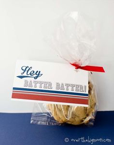 a bag filled with cookies sitting on top of a blue tablecloth next to a white wall