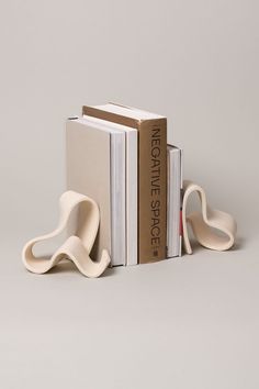 two bookends made out of books and one is shaped like an elephant's tail