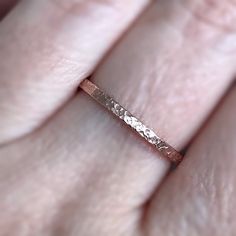 "The textured band on this rustic rose gold ring will dazzle on its own or add dimension to your layering ring stack. This minimalist ring is also available in 14K gold fill, sterling silver and antique silver. Simply choose your size and finish from the drop down menus. {LISTING FEATURES} ~ 14K Rose Gold Fill ~ Rustic ring ~ Raw silk textured band ~ Layering ring ~ Easily stackable with my other ring bands (see below for link to more rings) ~ Can be mixed and matched and stacked with my rings i Rose Gold Stackable Midi Rings For Promise, Dainty Rose Gold Bands For Gift, Anniversary Rose Gold Hammered Stackable Rings, Rose Gold Promise Midi Rings With Round Band, Delicate Rose Gold Stackable Rings With Round Band, Hammered Rose Gold Stackable Rings As Gift, Rose Gold Hammered Midi Rings, Wedding Hammered Rose Gold Stackable Rings, Hammered Rose Gold Stackable Rings For Wedding