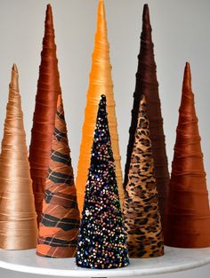 there are many different types of cones on the shelf in front of the white wall