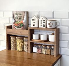 a wooden shelf filled with spices on top of a counter