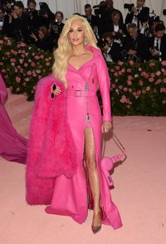 lady in pink dress and fur coat posing for the camera