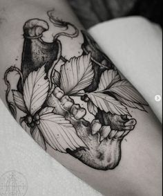 a black and white photo of a heart with flowers on it's left arm