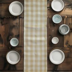 the table is set with dishes and placemats for two people to sit at