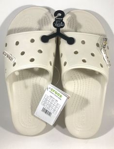 CROCS  Classic Crocs Slide  Comes with "Crocs" logo Jibbitz Attached to Each Slide Style # 206121-160 Unisex  Men's Size 11 (M11) Beige Brand New with Tags and Store Display Hanger Attached Photos were taken by me and show the exact item you will receive Please make sure this is the size you need.  All Sales Are FINAL I'm available to answer any questions you may have! QUICK SHIPPING!  CAREFULLY PACKED IN A BOX! The shipping cost listed above was automatically calculated by the Post Office's ACTUAL cost to ship this package’s weight to your zip code on file with eBay.  I pack them with care in a box, not an envelope to avoid arriving damaged. Crocs Classic Slide, Crocs Logo, Crocs Slide, Crocs Slides, Classic Crocs, Mens Shoes Sandals, Store Display, Zip Code, In A Box