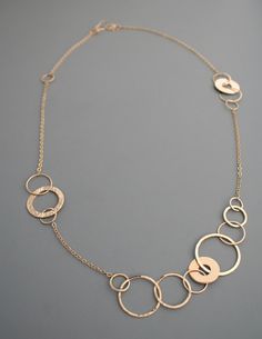 "This stunning asymmetric necklace has such a fun and modern look to it. It is completely crafted by hand from 14k gold filled metal. The links have a shiny finish which makes the necklace sparkle in the light as you move. The total length is about 25\" and the links measure between 1/4\" and 1\" wide. The chain ends in my signature handmade clasp.  Rachel Wilder Jewelry is all handmade solely by the artist. I create my designs by hand starting with straight wire which I shape, fuse, hammer and Elegant Circle Hammered Necklaces, Elegant Hammered Circle Necklace, Elegant Full Circle Hammered Jewelry, Elegant Hammered Link Chain Necklace, Elegant Hammered Link Necklace, Elegant Hammered Rose Gold Necklace, Diamond Infinity Necklace, Gemstone Pendant Jewelry, Gold Filled Necklace