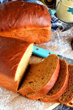 a loaf of bread with a knife cut in half