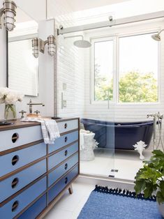 a blue and white bathroom with a claw foot tub