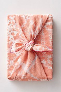 an orange and white cloth wrapped in a bow