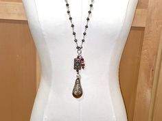 Rich, luxe, one of a kind, this unique necklace is pretty breathtaking. The chain is made of large, faceted, shiny silver PYRITE rondelles, and, without accouterments, measures 32" in length, which means you get a 16" drop. If you add the multiple pendants and accouterments at the bottom, you gain an additional 5 1/4" of wearable drop length. This lovely piece slips over the head with ease. The pendants are TIBETAN CARNELIAN, handmade by the tribespeople of Tibet. The FOCI pendant at the bottom is a fantastic 2 3/8" long and1 1/4" wide Tibetan smooth and gorgeous carnelian stone. It is capped almost 3/4" of the way down with magnificent TIBETAN STERLING SILVER which is ornately carved using a repousse technique. Above this piece is a secondary Tibetan sterling piece, a rectangular massivel Silver Teardrop Necklaces With Unique Variations, Silver Carnelian Jewelry With Large Pendant, Elegant Carnelian Pendant Necklace, Elegant Carnelian Jewelry With Large Pendant, Elegant Carnelian Necklace With Large Pendant, Silver Bohemian Jewelry With Detachable Pendant, Silver Carnelian Spiritual Jewelry, Silver Spiritual Jewelry With Carnelian, Spiritual Silver Carnelian Jewelry