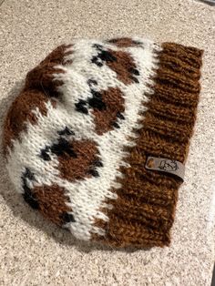 a brown and white hat sitting on top of a counter