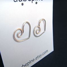 I've handcrafted these heart earrings out of sterling silver. These are fun and versatile, great to wear every day. Earrings are approximately 1.2 cm x 1.4 cm wide. Since I make these shapes completely by hand, there may be slight variations. See more~ Post earrings- http://www.etsy.com/shop/aubepine?section_id=6718986 Silver earrings- http://www.etsy.com/shop/aubepine?section_id=6718998 The rest of my jewelry shop- http://aubepine.etsy.com/ Jewelry Heart, Love Jewelry, Diy Wire Jewelry, Ear Rings, Green Quartz, Moonstone Necklace, Quartz Earrings, Sterling Silver Hoops, Heart Jewelry