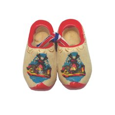 a pair of children's shoes with an image of a boat on the water