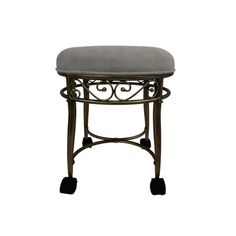 an iron stool with a gray cushion on it