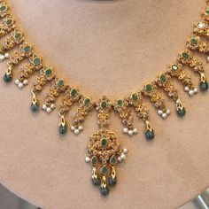 A lovely decorative piece featuring faceted and cabochon emerald drops, natural seed pearls and a plethora of diamonds! They are all set in 22k yellow gold giving the necklace a bright yellow color.    Length: 15.5 inches    Weight: 38.3 grams Traditional Gold Emerald Necklaces, Traditional Green Emerald Necklace In 22k Gold, Festive 22k Gold Elegant Emerald Necklace, Festive Yellow Gold Emerald Necklace With Gemstone, 22k Gold Green Bridal Necklace, 22k Gold Green Necklace For Festivals, Exquisite Green Necklace For Festive Occasions, Green 22k Gold Necklace For Festivals, Elegant 22k Gold Jeweled Jewelry