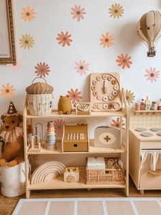 a child's playroom with toys and decor on the shelves, including a clock