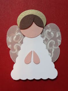 an angel cut out from paper on a red background