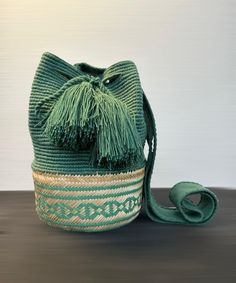 100% handmade, exclusive design. Emerald green Wayuu backpack Length 10 inches Handle that hangs on the shoulder 19 inches Width 12 inches Casual Handwoven Crossbody Bucket Bag, Braided Bucket Crochet Bag For Travel, Casual Bucket Bag With Braided Details, Green Crossbody Backpack With Adjustable Strap, Braided Bucket Shoulder Bag For Travel, Casual Braided Bucket Bag, Casual Green Bucket Bag For Beach, Green Bucket Bag With Adjustable Strap, Travel Braided Bucket Bag