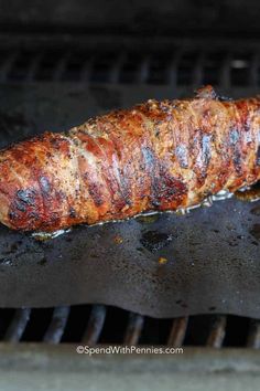 there is a piece of meat cooking on the grill with it's end being grilled