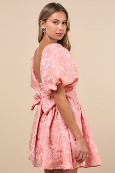 You'll be all sweetness in an adorably playful look like the Sister Jane Recital Pink Jacquard Floral Puff Sleeve Mini Dress! Lightweight woven fabric boasts a gorgeous floral jacquard design throughout as it shapes statement-making puff sleeves (with elastic at the cuffs) that frame a bodice with a square neckline and a low-cut back. Wide sashes tie at the back allow for a custom fit, atop a flaring skirt with trendy gathered side panels that lends a flirtatious finish. Hidden zipper at back. Fit: This garment fits true to size. Length: Mid-thigh. Size uk m/us 6 measures 33" from shoulder to hem. Bust: Great for any cup size. Waist: Fitted - very fitted at natural waist. Hip: Not Fitted - fuller skirt allows room for hips. Undergarments: May be worn with a strapless bra, adhesive bra, pet