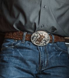 We love a classic beauty. This American Beauty Bull Rider Belt Buckle is as classic western as you can get. It is silver-finished and oval-shaped with filigree etchings. It holds a bull rider in the center that is gold-finished. It shines like a full moon in the night sky! Standard 1.5 inch belt swivel. Dimensions: Width 3.976000 Height 3.032000 Length 0.201000 Materials: 99.9% fine silver and 24K yellow gold plated over a brass base. Paint. Montana Armor to help prevent tarnish. Montana Silvers Cowboy Belt Buckle Aesthetic, Moon In The Night Sky, Cowboy Belt Buckles, Bull Rider, Cowboy Aesthetic, Cowboy Belt, Looks Country, Western Accessories, Western Store