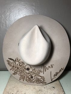 "We love our modern country brides! We design unique hats with our beautiful brides in mind, this is the perfect modern country accessory to wear on your big day and beyond! This hat is perfect for the bride who loves minimal custom design! The perfect hat for every season of weddings. These hats are felt/wool with a wide, flat brim.  Sizes vary for different colors. For Cream and Silverbelly sizes are small, medium, and large. Ivory hats are one size fits all. Hats come in four colors; Cream, S Burned Wedding Hat, Bride Felt Hat, Western Wedding Hat, Custom Wedding Hats, Bridal Cowgirl Hat, Western Wide Brim Wedding Hat, Western Style Wedding Hat With Flat Brim, Bohemian Wide Brim Wedding Hat, Western Style Flat Brim Wedding Hat