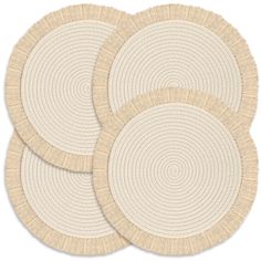 three round placemats in beige and white with circular designs on the top, set of