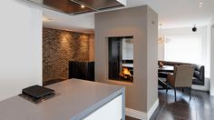 a modern kitchen with an oven, stove and dining room table in the back ground