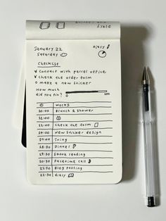 a notepad with some writing on it next to a pen