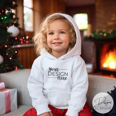 Introducing our baby toddler holiday sweatshirt mockup! A perfect mock for a diverse Christmas or New Years design, and more! Our mockup is ideal for Gildan 18500, Bella Canvas, Comfort colors 1567, or universal brands. Compliment your unique design this holiday season featuring this high quality digital mockup, showcasing an toddler / child modeling a white Hoodie Pullover Sweatshirt with Christmas backdrop. This mockup will help spread the holiday cheer in your Etsy shop while elevating your d Customizable White Hoodie For Gift, Customizable White Hoodie As Gift, White Hooded Sweatshirt Gift, Toddler Modeling, Holidays With Toddlers, Christmas Backdrop, Digital Mockup, Hoodie Mockup, White Pullover