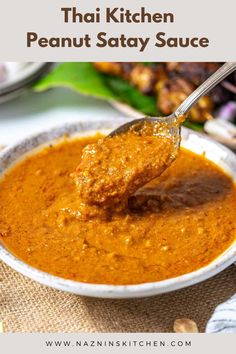 a spoonful of thai peanut sauce in a white bowl with the title above it