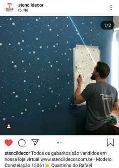 a man is painting stars on the wall