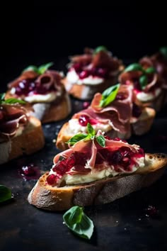 several pieces of bread with meat and cheese on them, garnished with leaves