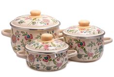 three pieces of ceramic covered casserole set with floral designs on the lids and handles