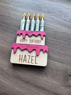 a wooden birthday card with candles on it