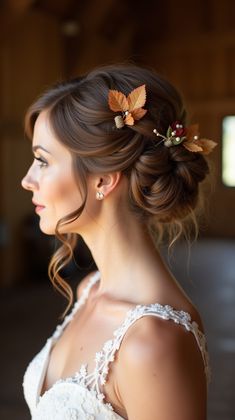 a woman wearing a wedding dress and hair comb with leaves in it's hair