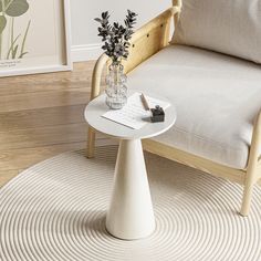 a white table sitting on top of a wooden floor next to a chair and potted plant