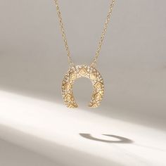 Elevate your style with our exquisite Pave Diamond Horseshoe Necklace. This unique and beautifully designed charm necklace not only adds a touch of elegance to your daily attire but also carries a profound symbol of good luck. Crafted with meticulous attention to detail, this necklace features a genuine 14k solid gold chain, adding a touch of luxury to your everyday look. The horseshoe pendant is adorned with dazzling pave real diamonds, creating a brilliant shimmer that catches the eye and radiates charm. Features  * Made to Order  * Gold KT: 14KT  * Custom Gold Color: Yellow Gold  * Charm 16.30x17.30 mm  * Charm Thickness: 2.20mm * Diamond Color-Clarity: D-E-F color VVS clarity (excellent ideal cut)  * Total Ctw: 0.25 ctw  * Ready to Ship in 5-7 Business Days ✓ We care about the environm Diamond Horseshoe Necklace, Elegant Gold Horseshoe Jewelry, Luxury Gold Horseshoe-shaped Jewelry, Gold Horseshoe Jewelry For Anniversary, Luxury Gold Horseshoe Jewelry, Gold Diamond Horseshoe Jewelry, Gold Horseshoe Diamond Jewelry, Gold Horseshoe Necklace With Adjustable Chain, Gold Horseshoe Necklace For Gift