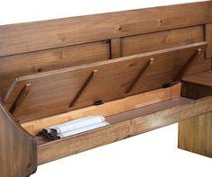 a wooden bench with two benches on each side and an open drawer underneath the bench