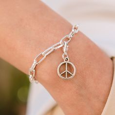 Express your desire for peace with the Peace Sign charm for Lizzy James charm bracelets and necklaces. An easy to use lobster clasp comes with this charm which allows you to put it on where you want, and take it off when you want. The dimensions are height 14 mm width 14 mm. Adjustable Spiritual Jewelry With Peace Sign, Turquoise Peace Sign Jewelry, Adjustable Sterling Silver Peace Sign Jewelry, Peace Sign Jewelry, Peace Sign Necklace Hippie, Symbolic Jewelry, Lobster Clasp, Peace Sign, Charm Bracelet