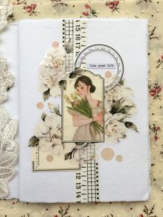 an altered book with flowers and lace on it