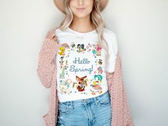 "Hello Spring! Vintage Baby Animals Graphic Tee Wave Text (Unisex Bella Canvas for Women / Men) UNISEX SIZING:                Our graphic tees are longer length styled making a great addition to any wardrobe. Layer with a cardigan or flannel, throw on some distressed jeans and booties and you are ready to go! Dress them up or down. For a more feminine look, roll the sleeves, tie a not, or half (French) tuck. The longer length also makes them great with leggings.             Small will fit youth ages 12 to 15 depending on the typical size of child/youth, XS will fit children ages 9 to 11. These crew neck tees are Bella brand and unisex, which means they are similar to a traditional men's size.        AVAILABLE SIZES:                  XS (0/2) Small - Length, 28\", Width, 18\" (4/6) Medium - Long Sleeve Top With Front Print For Spring, Spring Long Sleeve Top With Front Print, Spring Fun Tops With Cartoon Print, Fun Cartoon Print Tops For Spring, Fun Cartoon Print Spring Tops, Spring Cartoon Print T-shirt, Spring Cotton Tops With Character Print, Playful Cartoon Print Tops For Spring, White Tops With Character Print For Spring