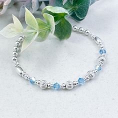 This elegant sterling silver bracelet featuring Aquamarine Swarovski crystals makes the ideal gift for those who celebrate their birthday in March  March is represented in the Swarovski birthstone chart as Aquamarine, a stunning light blue crystal that symbolizes health, hope and youth  The eclectic mix of beautiful beads are strung on high quality, strong, professional jewellers' elastic meaning there are no fiddly clasps to deal with, simply roll the bracelet over your hand, and onto your wrist The bracelet is elegantly presented in a grey faux suede jewellery pouch, complete with aftercare instructions and a cleaning cloth, adding to its charm as an ideal gift ☽ SIZE: Available in wrist sizes: Small (17cm), Medium (18cm) or Large (19cm) If you're unsure about sizing please drop me a mes Sterling Silver Bracelets For May Birthstone Anniversary, Sterling Silver Round Bracelet With Birthstone For Anniversary, Adjustable Silver Crystal Bracelet With Birthstone, Adjustable Silver Birthstone Crystal Bracelet, Adjustable Sterling Silver Crystal Bracelet For Anniversary, Adjustable Birthstone Beaded Bracelets For Anniversary, Adjustable Silver Crystal Bracelet For Mother's Day, Adjustable Stackable Sterling Silver Bracelet For Anniversary, Hypoallergenic Beaded Bracelets For Anniversary