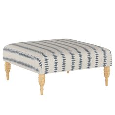 the foot stool is made out of wood and has an upholstered pattern on it