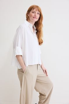 The Poplin Oversized Cropped Blouse is a contemporary twist on a classic wardrobe staple. Crafted from premium poplin fabric, this blouse effortlessly combines comfort, style, and versatility to elevate your everyday look Oversized Cotton Blouse With Placket, Poplin Short Sleeve Workwear Blouse, Chic Poplin Top With Relaxed Fit, Short Sleeve Poplin Blouse For Work, Modern Blouse With Spread Collar For Daywear, Oversized Poplin Tops For Spring, Relaxed Fit Poplin Top For Work, Casual Poplin Blouse For Workwear, Effortless Cotton Blouse With Shirttail Hem