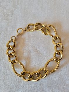 Vintage Trifari gold tone chain link bracelet.  A combination of large and small links, some twisted design and some smooth textured.  Measures 7 inches long.  Perfect classic addition to your wardrobe. Vintage Trifari, Chain Link Bracelet, Link Bracelets, Chain Link, Jewelry Bracelets, Gold Tones, Bracelet, Wardrobe, Chain